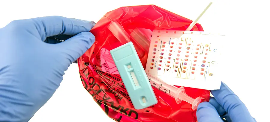 Disposal container; reducing medical waste disposal. Small Medical Waste sharps container with sharps for biohazand.