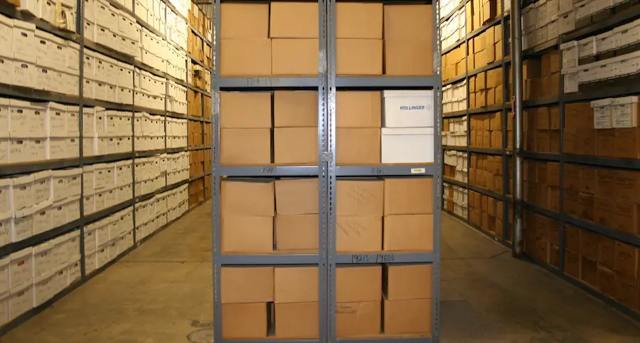 a large quantity of boxes are stored on racks at this records storage warehouse facility. the boxes contain files, documents, papers, and other business records. these photos may be of special interest to those in the records management industry.